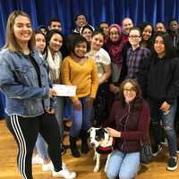 <p>Hackensack High School journalism students from all grades raised more than $800 for Pawsitively Forever. Seated is Laura Witzal with rescue pup Allie.</p>