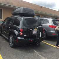 <p>Reporters surround O&#x27;Connors black Chevrolet in the Travelodge lot.</p>