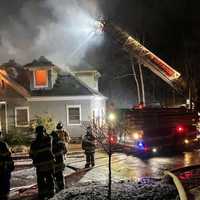 <p>Firefighters work to put out flames at a home in Montrose.</p>