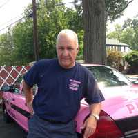 <p>John LaFalce, a Ridgefield volunteer firefighter and Pink Heals Bergen County president, with the organization's 2006 Ford patrol car.</p>