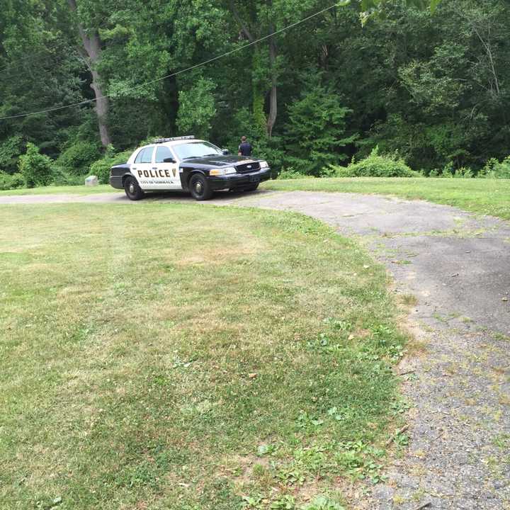 A Norwalk police cruiser is behind Roton Middle School as the search continues Friday for an elderly man who attacked a teenage girl.