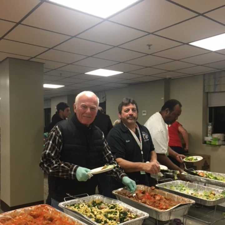 Elks Ed Flynn and Mike Picarello serve dinner for veterans at the Montrose VA.