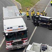 <p>The victim was walked to a waiting ambulance after her Honda CR-V landed on its passenger side entering southbound Route 17 in Ridgewood.</p>