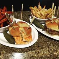 <p>The Burger Bar at Wegmans Montvale includes a Maple Onion Bacon Burger, right, and Jammin&#x27; Salmon, right.</p>