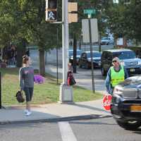 <p>A student and crossing guard stand near the busy intersection of South Front Street and East Clinton Avenue in Bergenfield, not far from the high school and railroad tracks. </p>