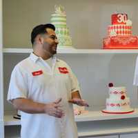 <p>Cake decorator Omar Lopez with Dwight Miller in the expanded shop. </p>