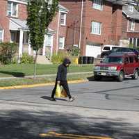 <p>A pedestrian crosses Hillside Avenue, one of the converted one-way roadways in the borough. </p>