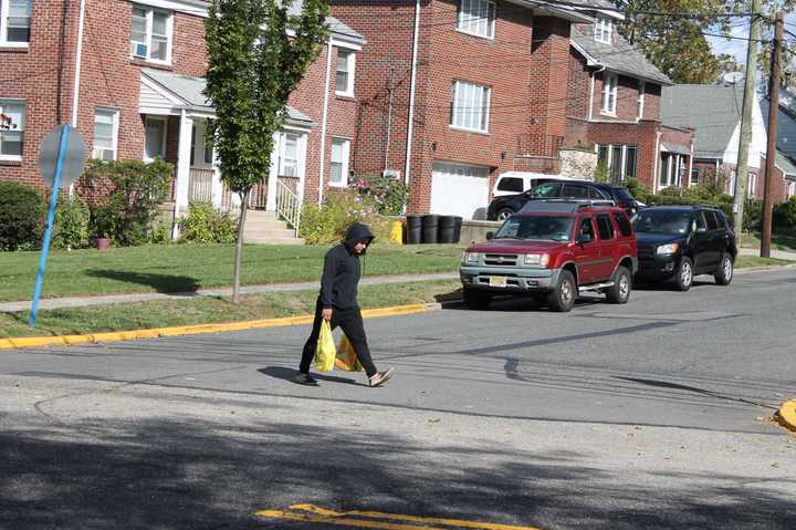 A pedestrian crosses Hillside Avenue, one of the converted one-way roadways in the borough. 