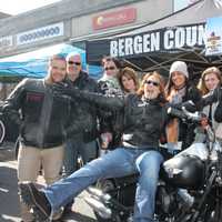 <p>Elizabeth DiGennaro and the staff of Bergen County Harley Davidson pose on the motorcycle they were offering in a contest in Ridgewood. </p>