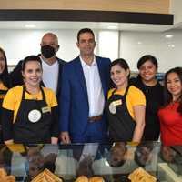 <p>Daniel Gonzalez (back left) and Yosvany Perez at the opening of El Fenix.</p>