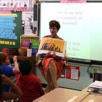 <p>A teacher shows off a book on the first day of classes in the Lakeland Central School District.</p>