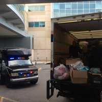 <p>A U-Haul truck and police bus await unloading at HUMC.</p>