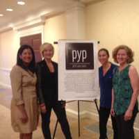 <p>Monica Huang, Karena Bailey, Steviann Martines and Lisa Getson stand by the Pitch Your Peers sign before the start of Pitch Night at the First Presbyterian Church in Greenwich, Oct. 6, 2016.</p>