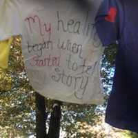 <p>One of the scores of T-shirts decorated by survivors of abuse hangs near Trumbull Library as part of The Clothesline Project.</p>