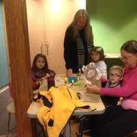 <p>William Salvatore, 3, of Fairfield, and his grandmother, Ellen Nelly, inspect the paper bag puppet he created at Stepping Stones&#x27;s Jumpstart Read for the Record program in Norwalk as other participants finish up their crafts.</p>