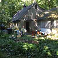 <p>A parrot is brought out of a building at 82 Newtown Turnpike in Weston on Friday. Officials seized hundreds of birds and snakes — both dead and alive — at the address this week.</p>