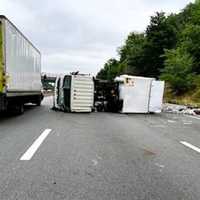 <p>The 20-foot truck landed on its side, spilling trash onto the right lane and shoulder of the westbound highway around 7 a.m. June 20.</p>