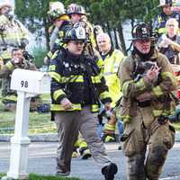 <p>Firefighters and police team up to rescue dog from fire on Deer Trail Road off Ruckman Avenue in Hillsdale at the Woodcliff Lake border on Saturday, May 17.</p>