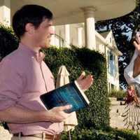 <p>Conor Grennan, of New Canaan with his book “Little Princes,” and Jim Luce of New York introducing him.</p>