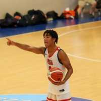 <p>Justin Price playing basketball at the Maccabiah Games</p>