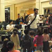 <p>Kit from Song for Seeds leads children in song.</p>