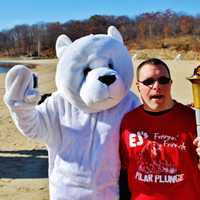 <p>A participant holds a torch at Lake Welch in Stony Point during Freezin&#x27; for a Reason.</p>