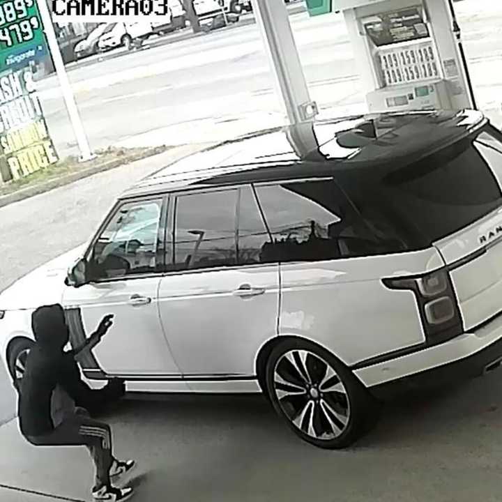 The suspect stealing the Range Rover at the gas station.