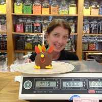 <p>Laurie Walker shows off one of her signature &quot;Happy Apples.&quot;</p>