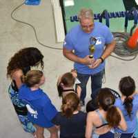 <p>Rye Y Coach Art Tiedermann holds a League Championship trophy won by the Rye Wave Ryeder swimmers.</p>