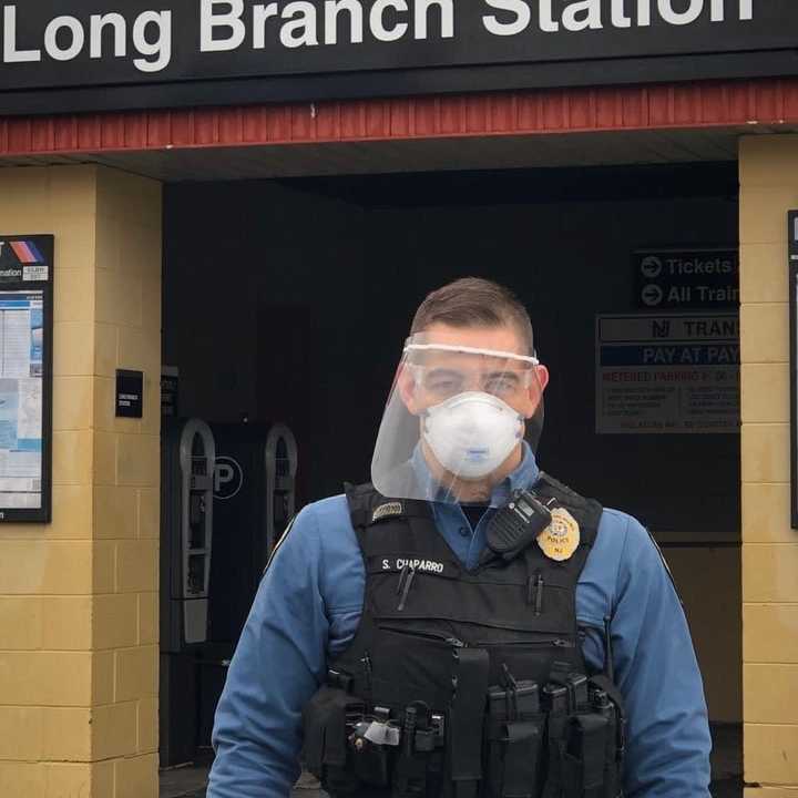 A police officer at Long Branch Police Department displays one of the many COVID-19 face shield donated by Siemens Corporate Technology.