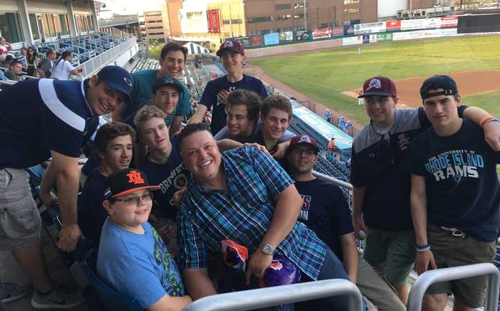 Luis Lopez with his baseball players at a Bluefish game.