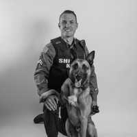 <p>Detective Corporal Michael McMahon and his K-9 partner, a Belgian Malinois named Kaiser</p>