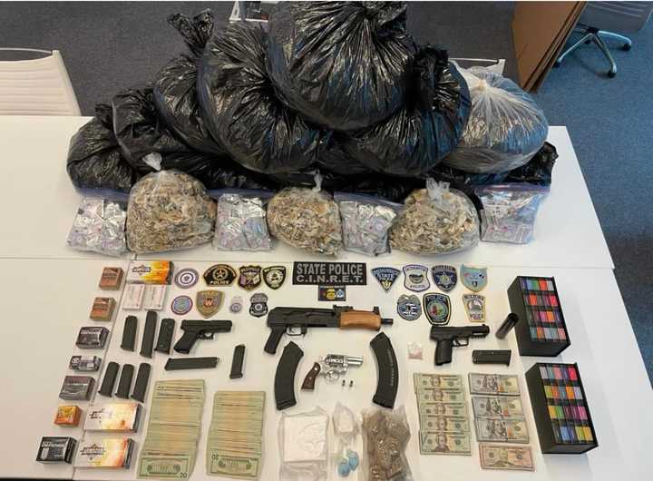 West Springfield police and State Troopers show off trash bags full of marijuana and magic mushrooms, along with smaller amounts of cocaine and ecstasy from a West Springfield raid last week. They also found $40,000 and a small arsenal of weapons.