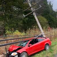 <p>A woman was pinned in her vehicle under live power lines following a crash.</p>