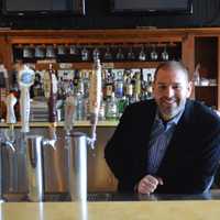 <p>Matt Van Allen stands behind the bar at the Old Forge Spirits &amp; Pub in Ringwood.</p>