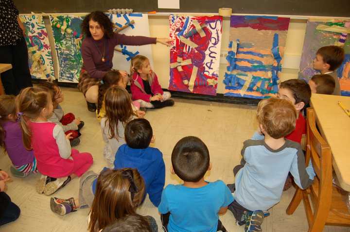 Putnam Valley kindergarten teacher Dorothy French helps students evaluate their marble projects.