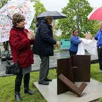 <p>From right, Mamaroneck Arts Council members Solange De Santis and Michael Rosenbaum, Recreation Superintendent Sandy Korkatzis, Mayor Norman Rosenblum, and Councilwoman Jaine Elkind Eney unveil a sculpture from Ernest Shaw’s “Ruin” series.</p>