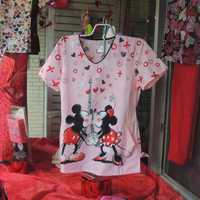 <p>Character scrubs are always popular! Mickey and Minnie kiss in the Valentine&#x27;s Day window.</p>