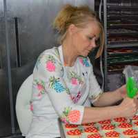 <p>Michele Braun decorates cookies for Teacher's Appreciation Week.</p>