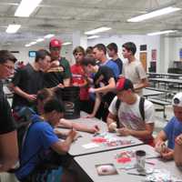 <p>The Westwood High School baseball team joins freshman Billy Cook in signing his 7,000th ball.</p>