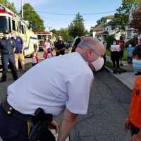 <p>Sheriff Gannon with Nesim on Kanouse Street in Boonton, where the family lives.</p>