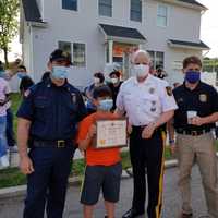 <p>From left: Boonton Fire Chief David Mayhood, 9-year-old Nesim Aktas, Morris County Sheriff James M. Gannon, Boonton Police Chief David Mayhood, and Boonton Lieutenant Royce Stafford.</p>