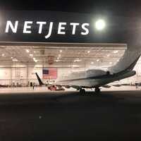 <p>Signature Flight Support (South) crew members towed the Challenger 350 to the hangar.</p>