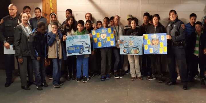 Members of the NRPD greet students from Isaac Young Middle School.