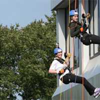 <p>Rappellers going down the side of a building.</p>