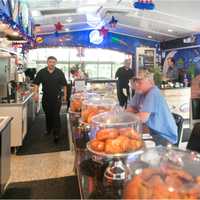 <p>Piles of doughnuts and other pastries sit at eye-level at the Oakland Diner counter.</p>