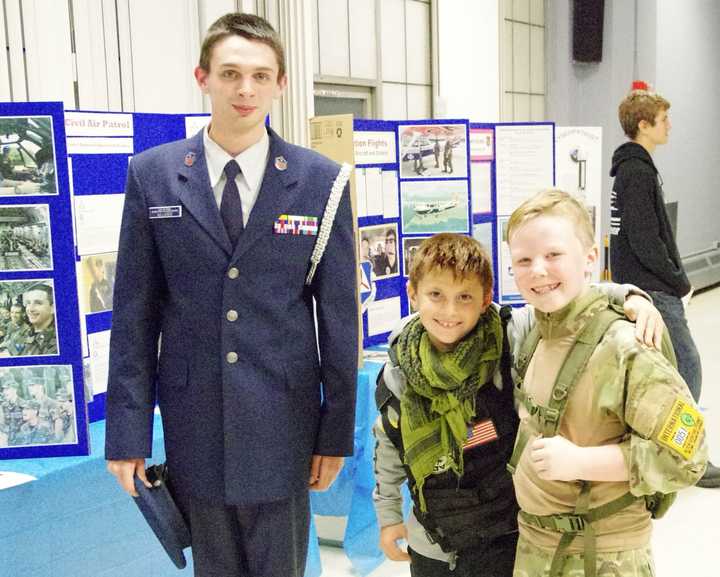 Cadet Master Sgt. Brian Kelleher with a pair of young visitors at the CAP Putnam County Composite Squadron open house on Friday.