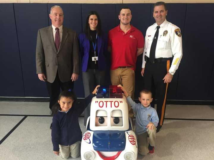 Saddle Brook Mayor Robert White, Principal Toni Violetti, a AAA representative, and Police Chief Robert Kugler attend the Otto the Auto program.