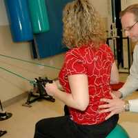 <p>Ben Gilbert, director of Outpatient Rehab Services at Burke Rehabilitation Hospital, helps one of his patients during a therapy session.</p>