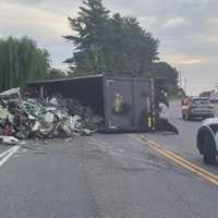 Garbage Truck Overturns In Stafford, Spills Trash On Road: Police